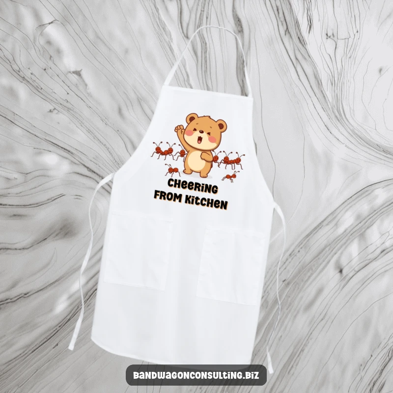 Funny apron featuring a determined bear cub character enthusiastically cheering for a group of marching ants.