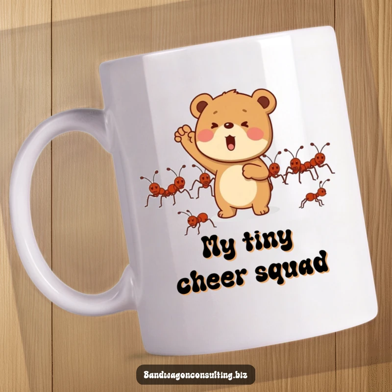 Funny mug showing a determined bear cub enthusiastically cheering for a line of marching ants.