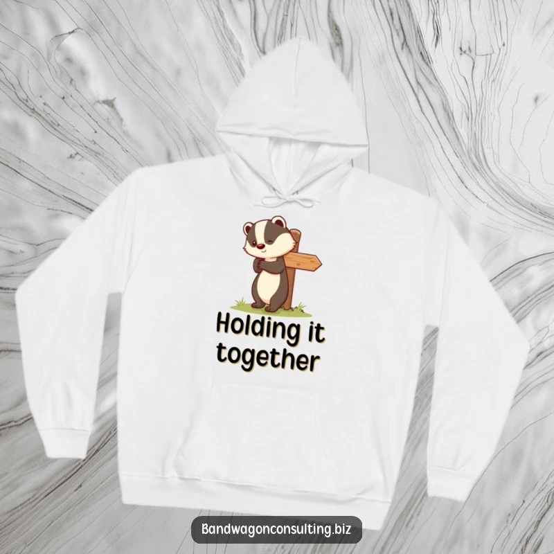 Funny hoodie featuring a sweet badger character dedicated to uprighting a tilted signpost with a cheerful expression.