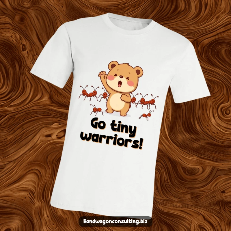 Funny t-shirt depicting a determined bear cub character enthusiastically cheering on a group of marching ants.