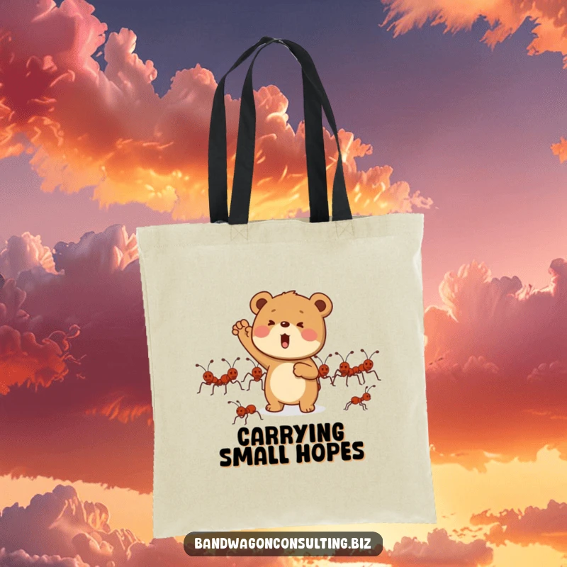 Funny tote bag showing a determined bear cub character enthusiastically cheering for a group of marching ants.